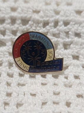 Special Olympics Enamel lapel pin It features motto "Skill Courage Sharing Joy"